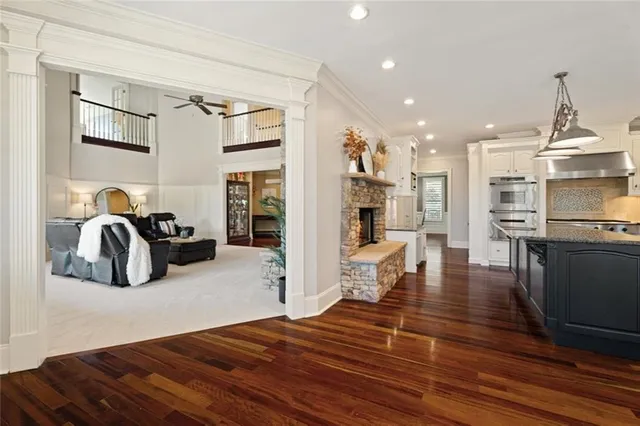 a spacious bedroom with a large bed and a chandelier