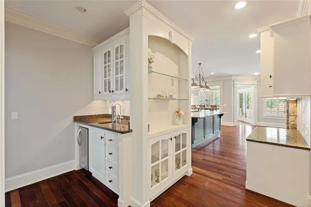 a view of a living room with wooden floor and stairs