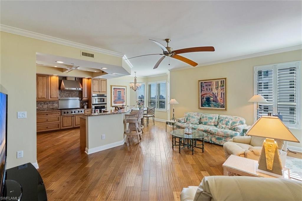 285 Grande Way, Unit 1501 Naples, FL 34110 - Photo 11 of 35 a living room with furniture and a view of kitchen