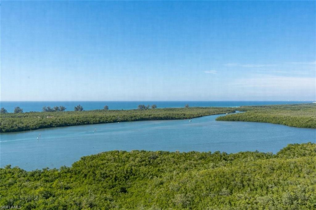 285 Grande Way, Unit 1501 Naples, FL 34110 - Photo 15 of 35 a view of a lake with houses in the back
