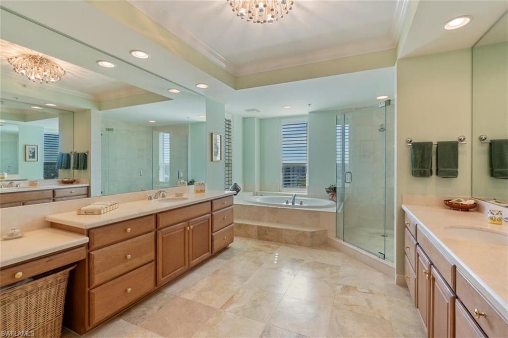 285 Grande Way, Unit 1501 Naples, FL 34110 - Photo 19 of 35 a large bathroom with a sink mirror and a bath tub