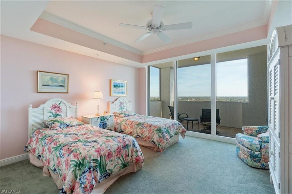 285 Grande Way, Unit 1501 Naples, FL 34110 - Photo 20 of 35 a bedroom with two beds and large window