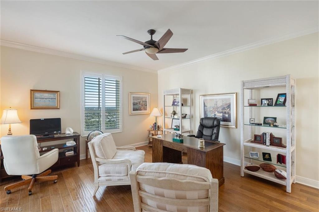 285 Grande Way, Unit 1501 Naples, FL 34110 - Photo 23 of 35 a living room with furniture and a book shelf