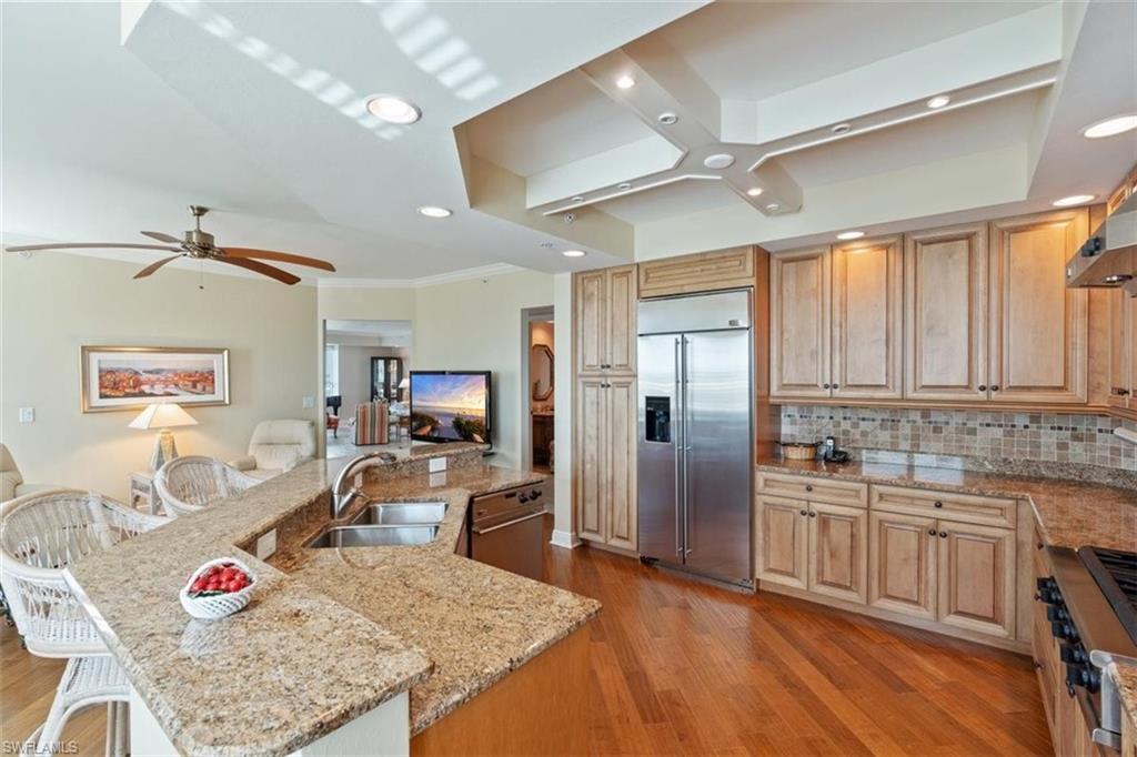 285 Grande Way, Unit 1501 Naples, FL 34110 - Photo 4 of 35 a kitchen with stainless steel appliances granite countertop a sink refrigerator and cabinets