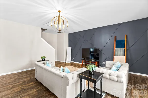a living room with fireplace furniture and a chandelier