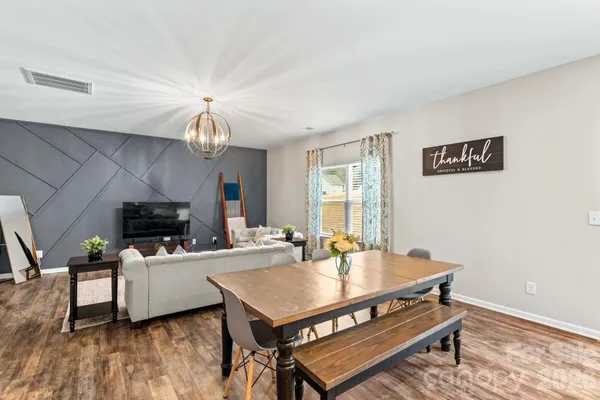 a living room with furniture a table and a fireplace