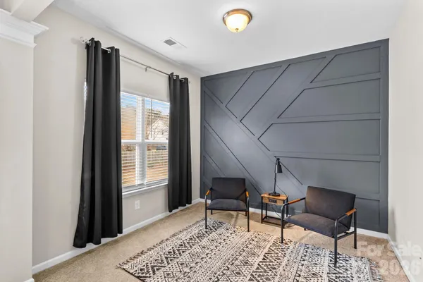 a chair and table in a room next to a window