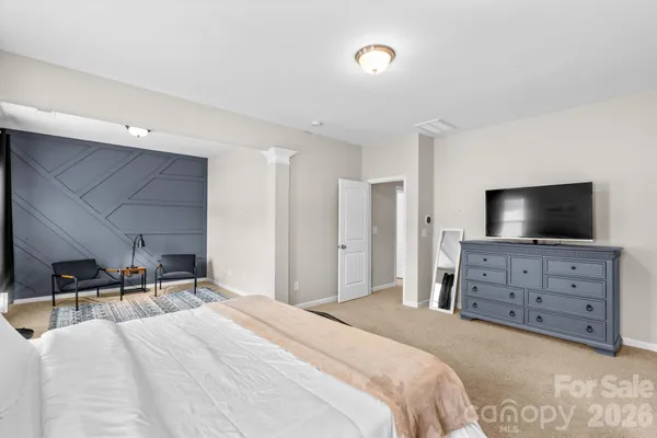 a bedroom with furniture and flat screen tv
