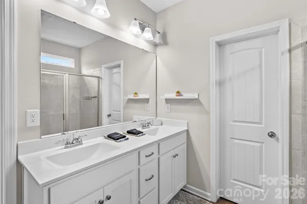 a bathroom with a sink double vanity and a mirror