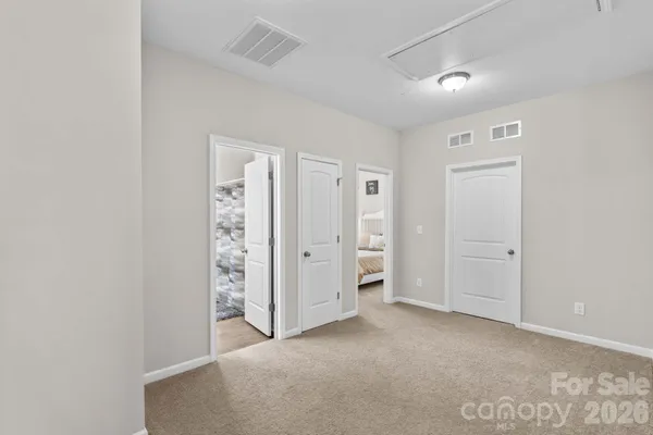 an empty room with closet and mirror