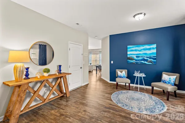 a living room with furniture and a mirror