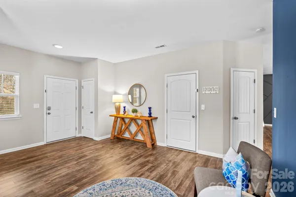 a bedroom with a bed and a wooden floor