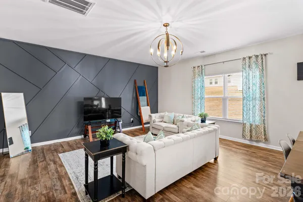 a living room with fireplace furniture and a wooden floor