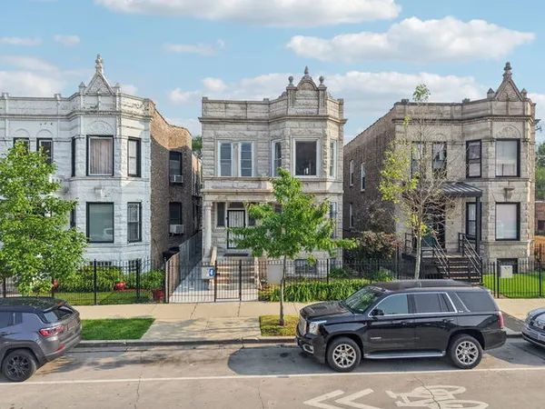 a car parked in front of a brick house