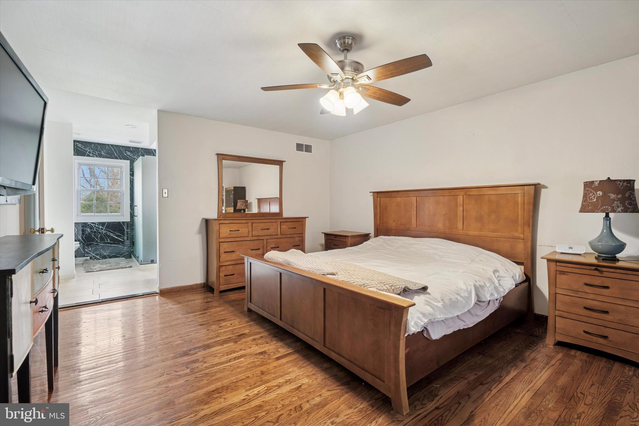 125 Red Lion Road Huntingdon Valley, PA 19006 - Photo 18 of 32 a bedroom with a bed and dresser with mirror