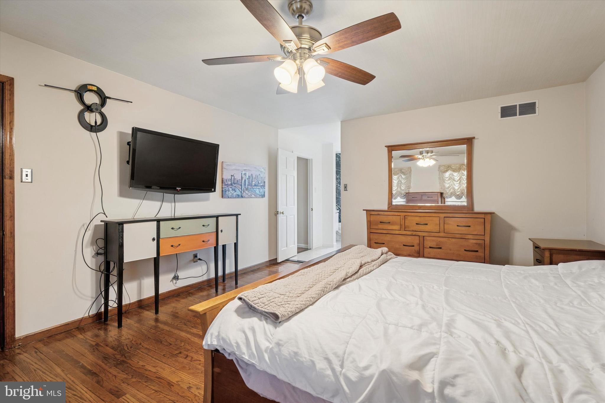 125 Red Lion Road Huntingdon Valley, PA 19006 - Photo 19 of 32 a bedroom with a bed and a flat screen tv