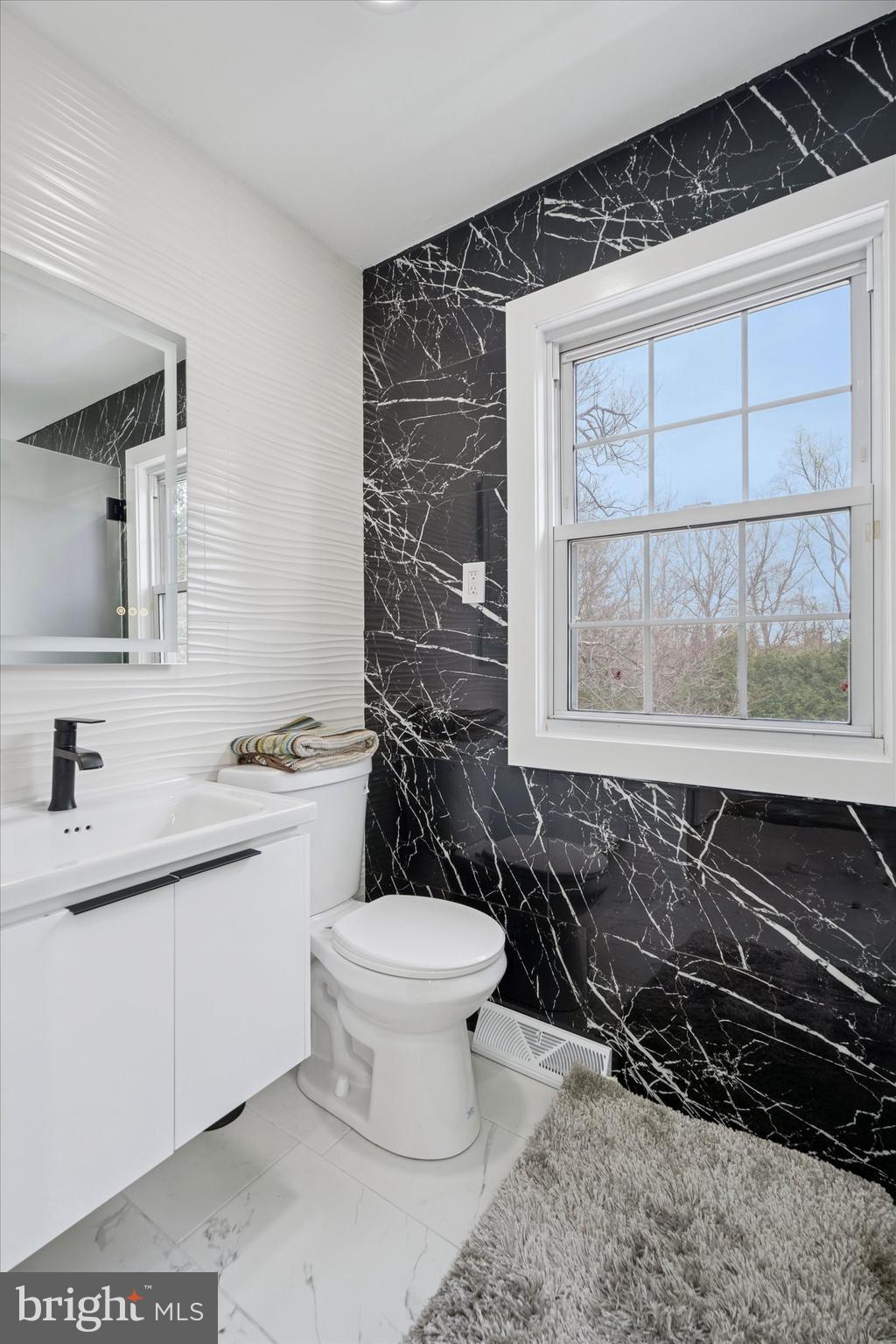 125 Red Lion Road Huntingdon Valley, PA 19006 - Photo 22 of 32 a bathroom with a toilet a sink and a mirror