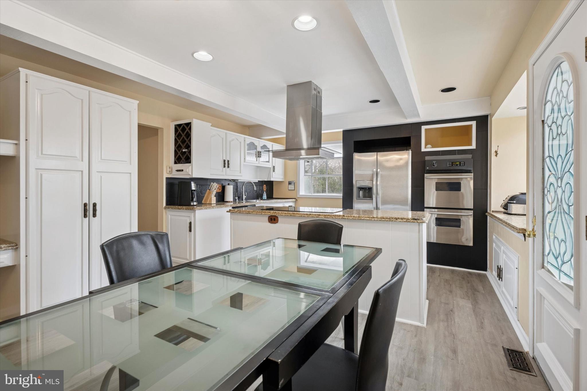 125 Red Lion Road Huntingdon Valley, PA 19006 - Photo 10 of 32 a living room with stainless steel appliances furniture a rug and a kitchen view