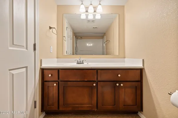 a bathroom with a sink vanity and a mirror