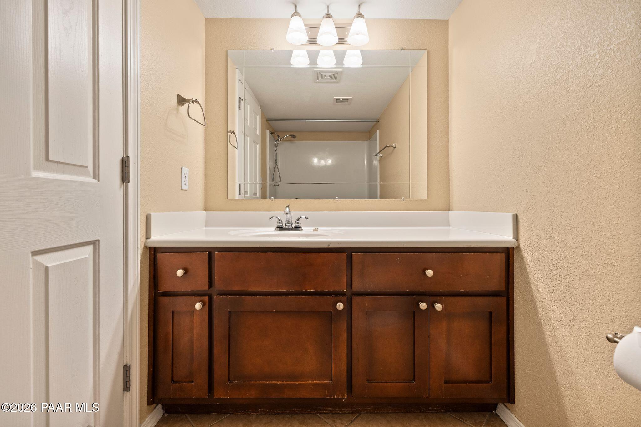 1001 East Goodwin Street, Unit 101 Prescott, AZ 86303 - Photo 12 of 23 a bathroom with a sink vanity and a mirror