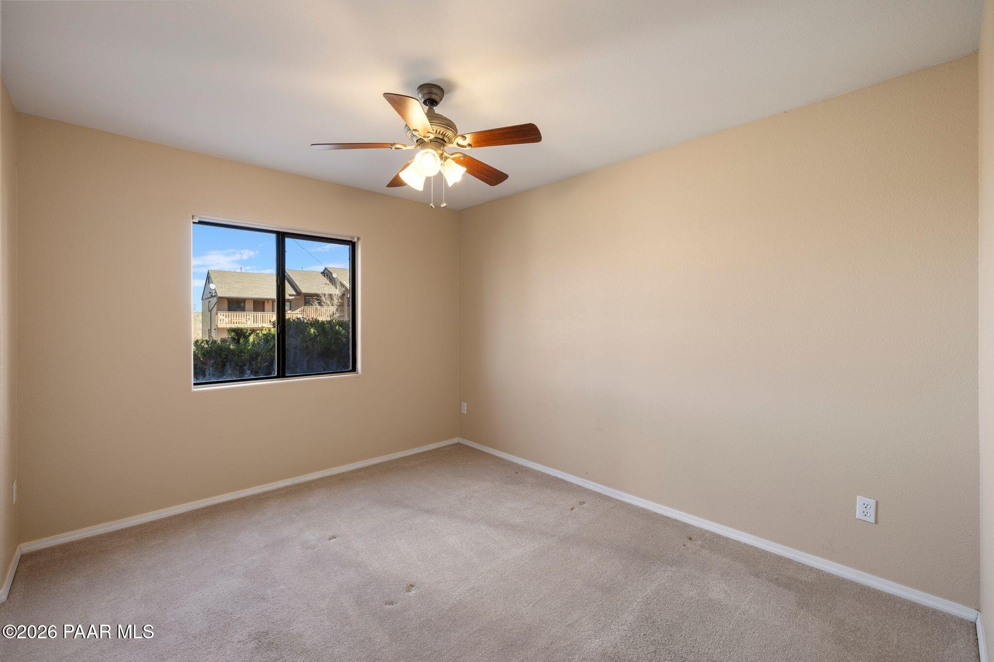 1001 East Goodwin Street, Unit 101 Prescott, AZ 86303 - Photo 14 of 23 an empty room with windows and fan
