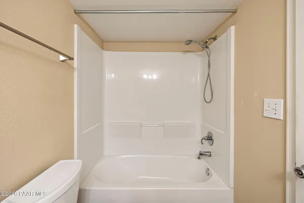 a bathroom with a bathtub a toilet and a shower