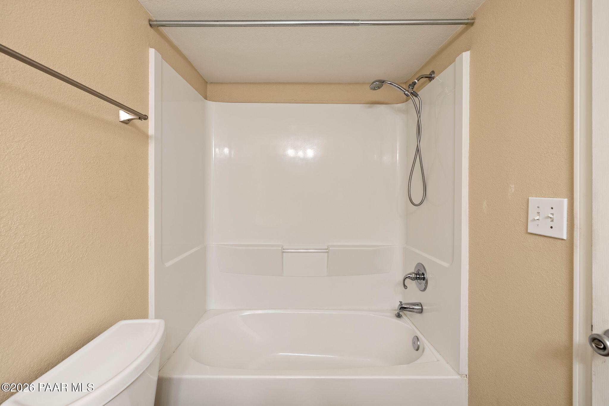 1001 East Goodwin Street, Unit 101 Prescott, AZ 86303 - Photo 16 of 23 a bathroom with a bathtub a toilet and a shower