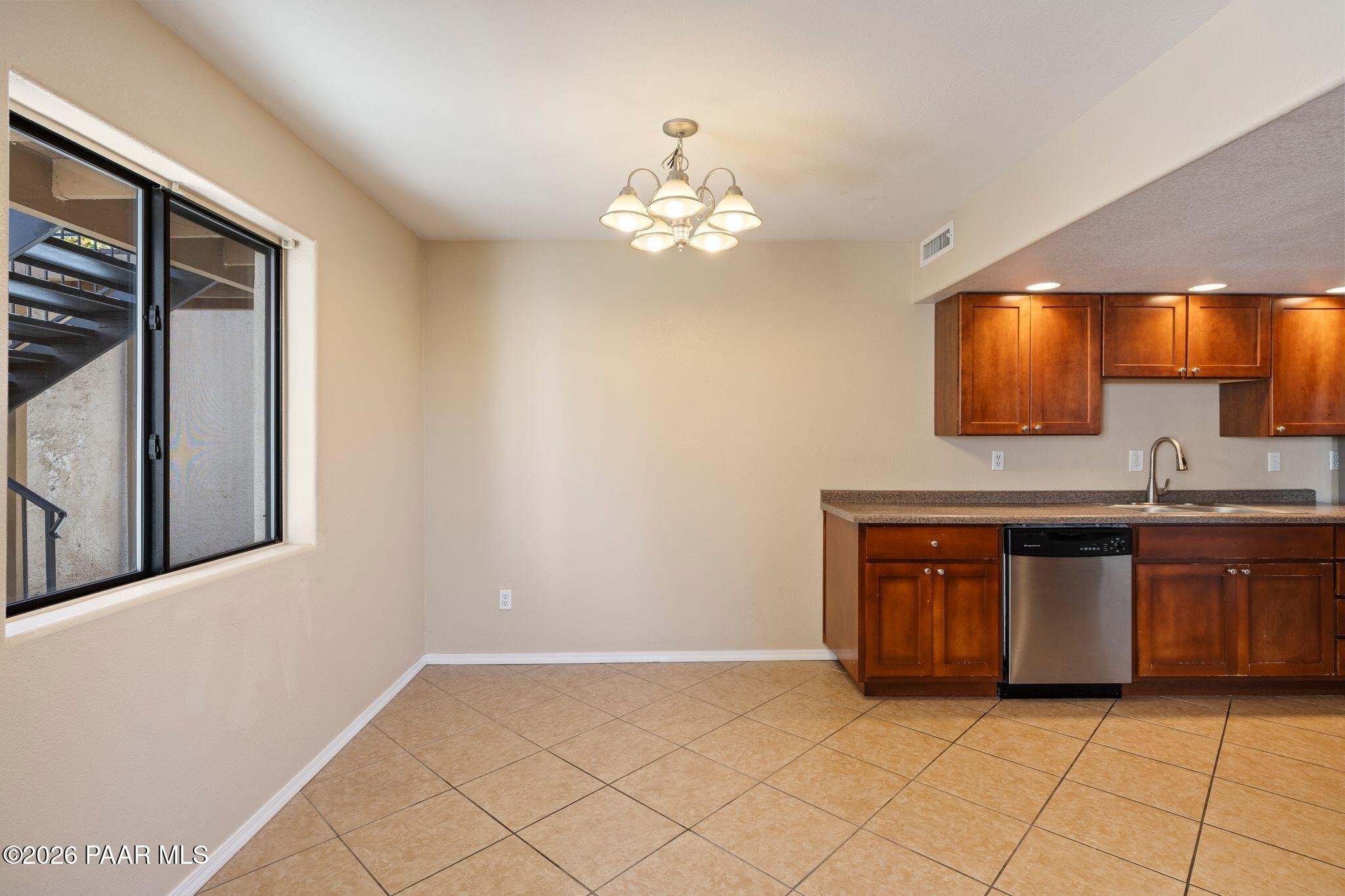 1001 East Goodwin Street, Unit 101 Prescott, AZ 86303 - Photo 17 of 23 a view of kitchen with granite countertop cabinets and window