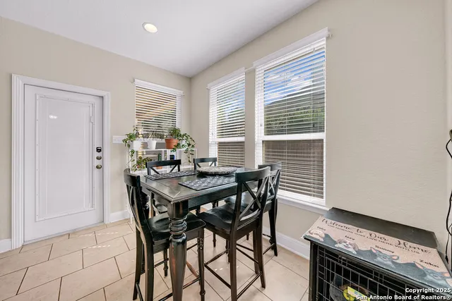 a view of a dining room with furniture and window