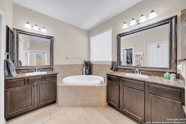 a bedroom with bed and a chandelier
