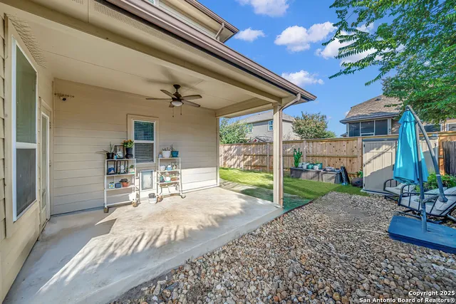 a backyard of a house with table and chairs