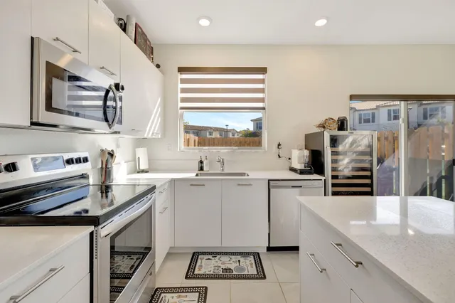 a kitchen with a sink stove and microwave