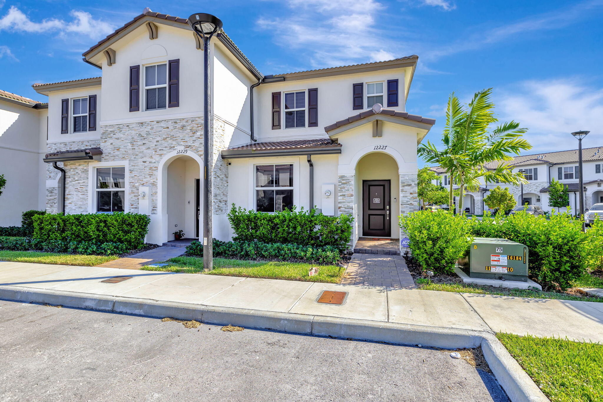 12227 Northwest 23rd Avenue Miami, FL 33167 - Photo 2 of 52 a front view of a house with garden