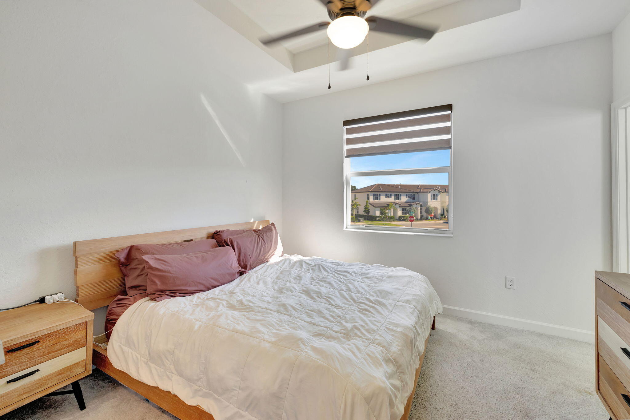 12227 Northwest 23rd Avenue Miami, FL 33167 - Photo 24 of 52 a bedroom with a bed and a chandelier