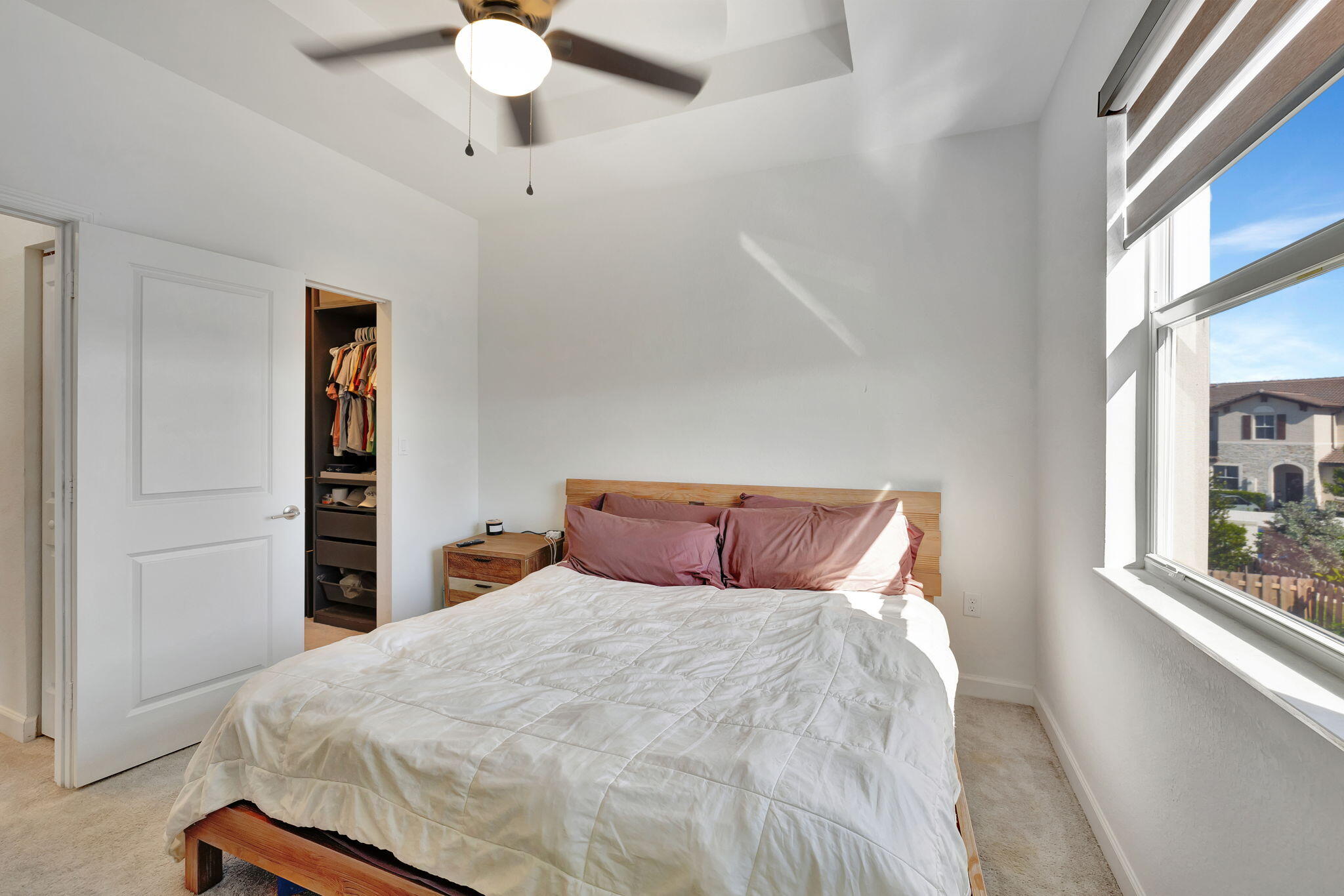 12227 Northwest 23rd Avenue Miami, FL 33167 - Photo 25 of 52 a bedroom with a large bed and a chandelier