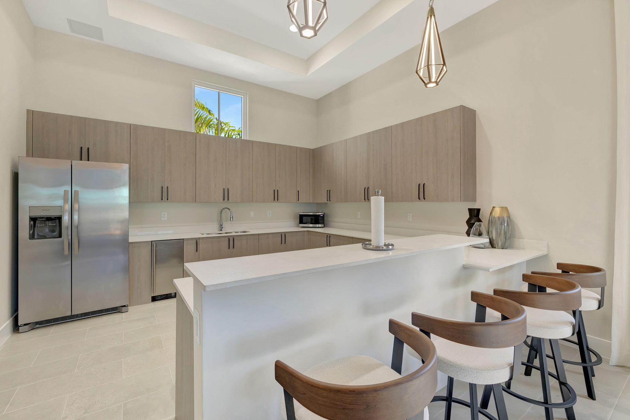 12227 Northwest 23rd Avenue Miami, FL 33167 - Photo 32 of 52 a kitchen with a dining table chairs and refrigerator