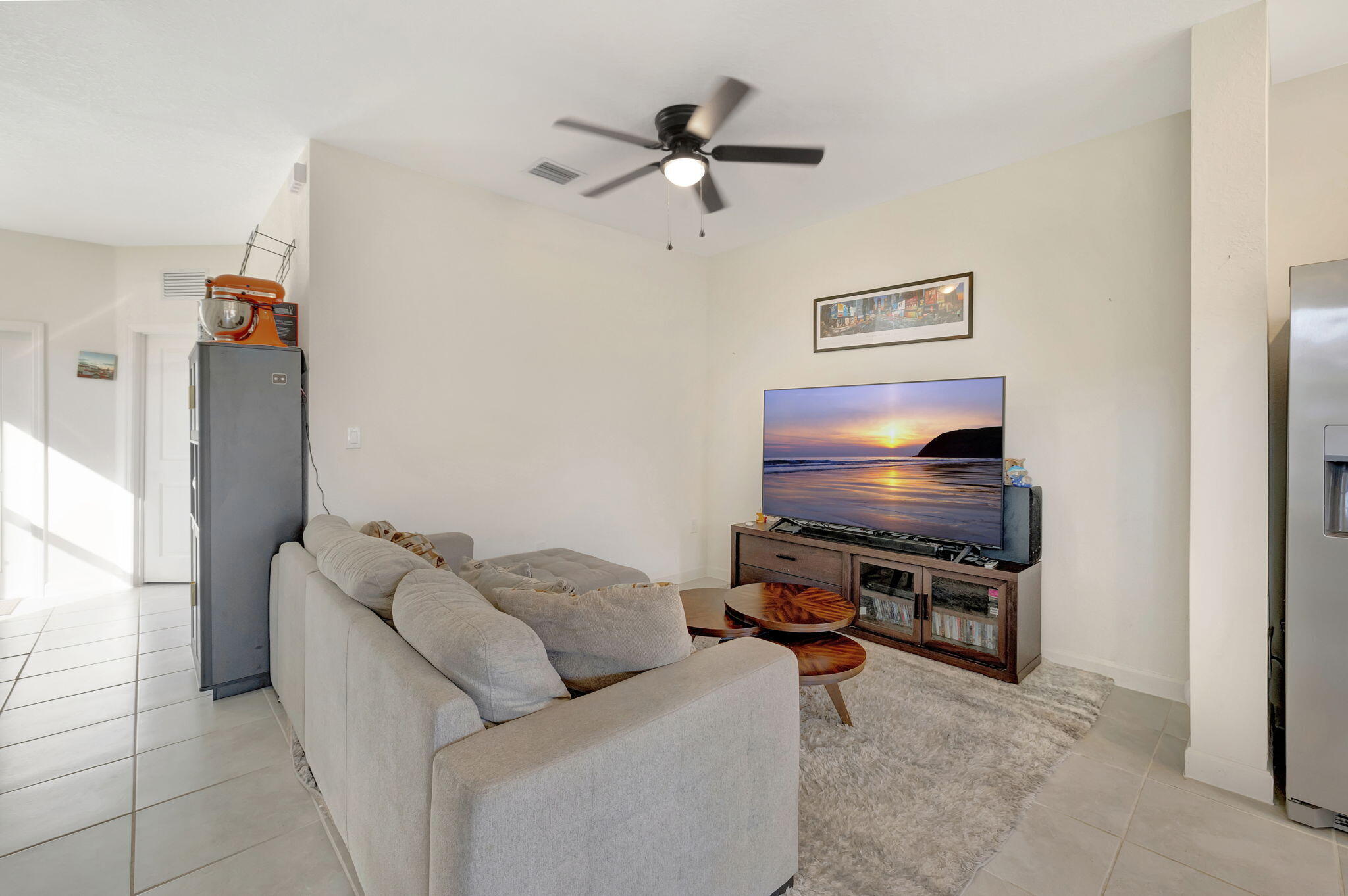 12227 Northwest 23rd Avenue Miami, FL 33167 - Photo 5 of 52 a living room with furniture and a flat screen tv