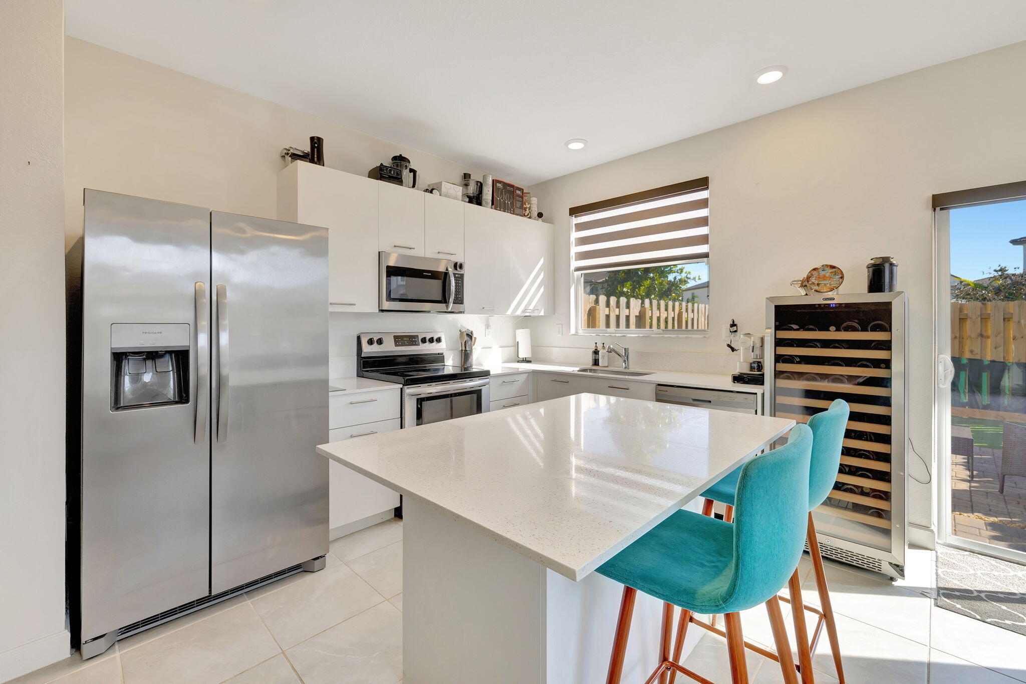 12227 Northwest 23rd Avenue Miami, FL 33167 - Photo 10 of 52 a kitchen with stainless steel appliances granite countertop a refrigerator a stove a sink and dishwasher