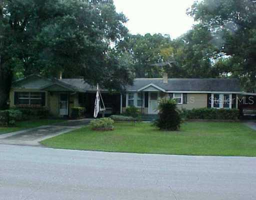 a front view of a house with a garden and yard