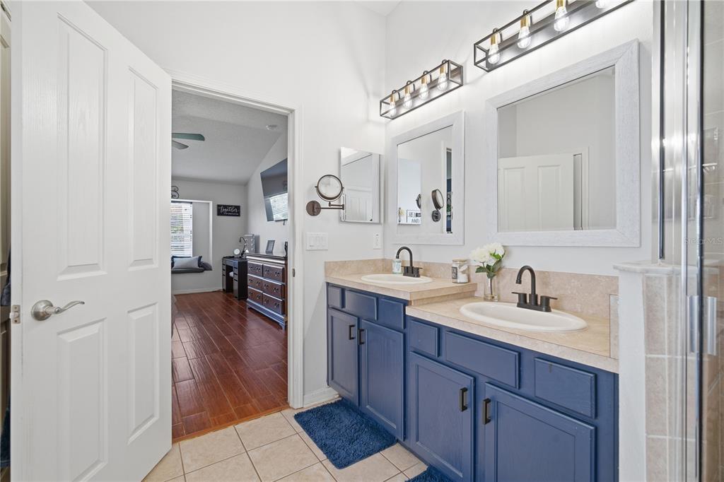6325 Bridgecrest Drive Lithia, FL 33547 - Photo 19 of 72 a en suite bathroom with a double vanity sink and a mirror