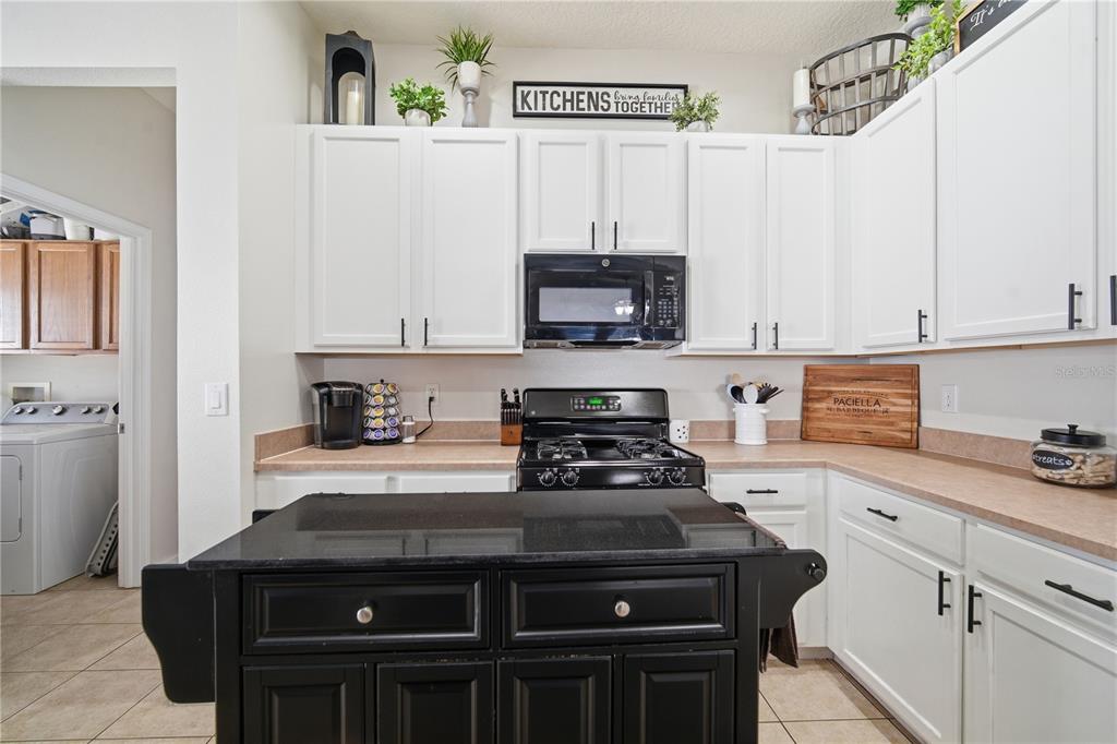 6325 Bridgecrest Drive Lithia, FL 33547 - Photo 23 of 72 a kitchen with a stove and a white cabinets