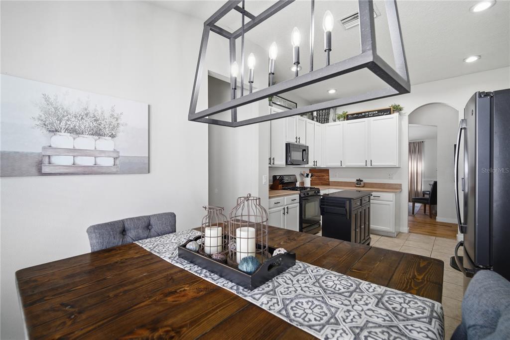6325 Bridgecrest Drive Lithia, FL 33547 - Photo 27 of 72 a kitchen with stainless steel appliances granite countertop a sink dishwasher a refrigerator and wooden cabinets with wooden floor