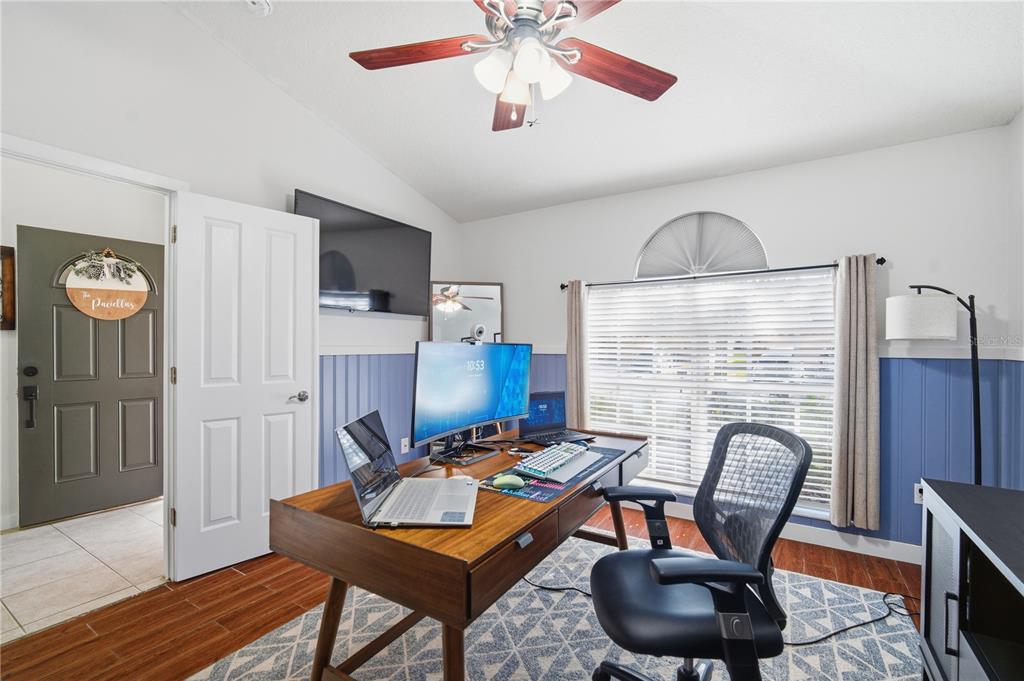 6325 Bridgecrest Drive Lithia, FL 33547 - Photo 36 of 72 a workspace with furniture a chandelier and wooden floor