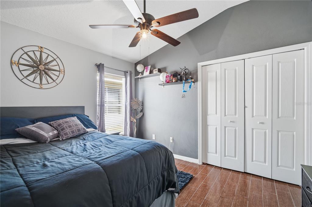 6325 Bridgecrest Drive Lithia, FL 33547 - Photo 37 of 72 a bedroom with a large bed and a chandelier