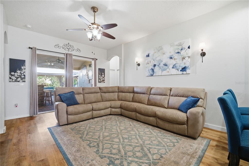 6325 Bridgecrest Drive Lithia, FL 33547 - Photo 41 of 72 a living room with furniture and a chandelier