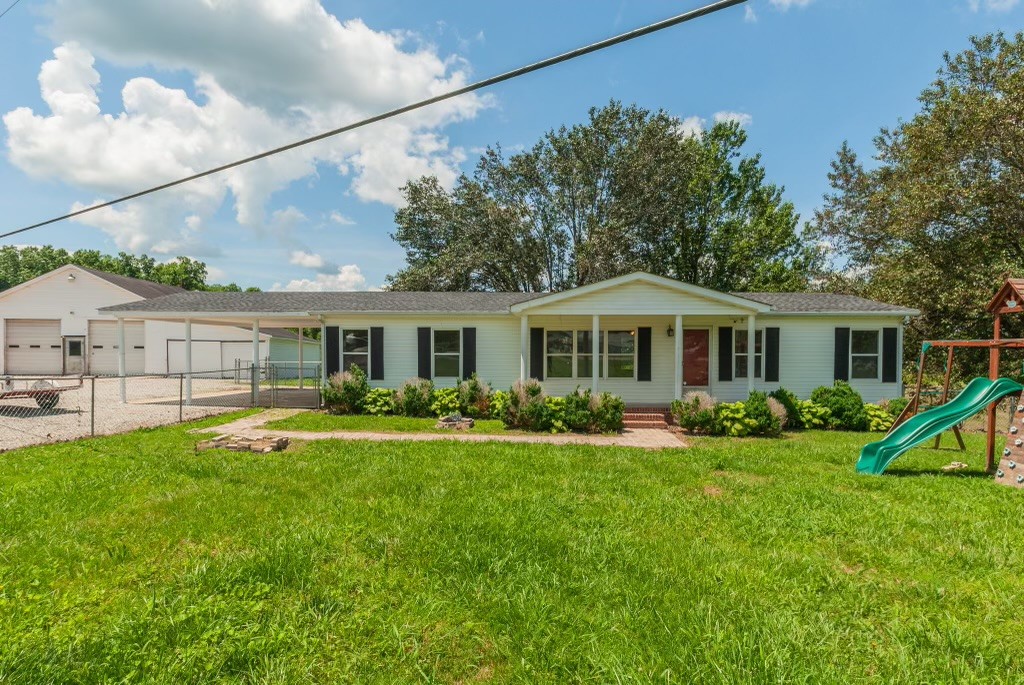 3257 Woolard Road Santa Fe, TN 38482 - Photo 1 of 1 a front view of a house with a yard and porch