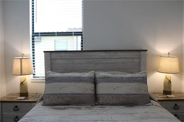 a bedroom with a bed and a window
