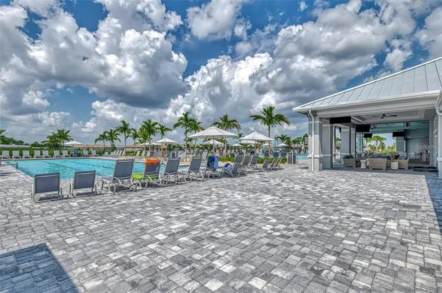 an aerial view of a house with a garden and lake view