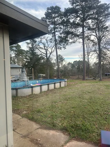 a view of a swimming pool with a patio