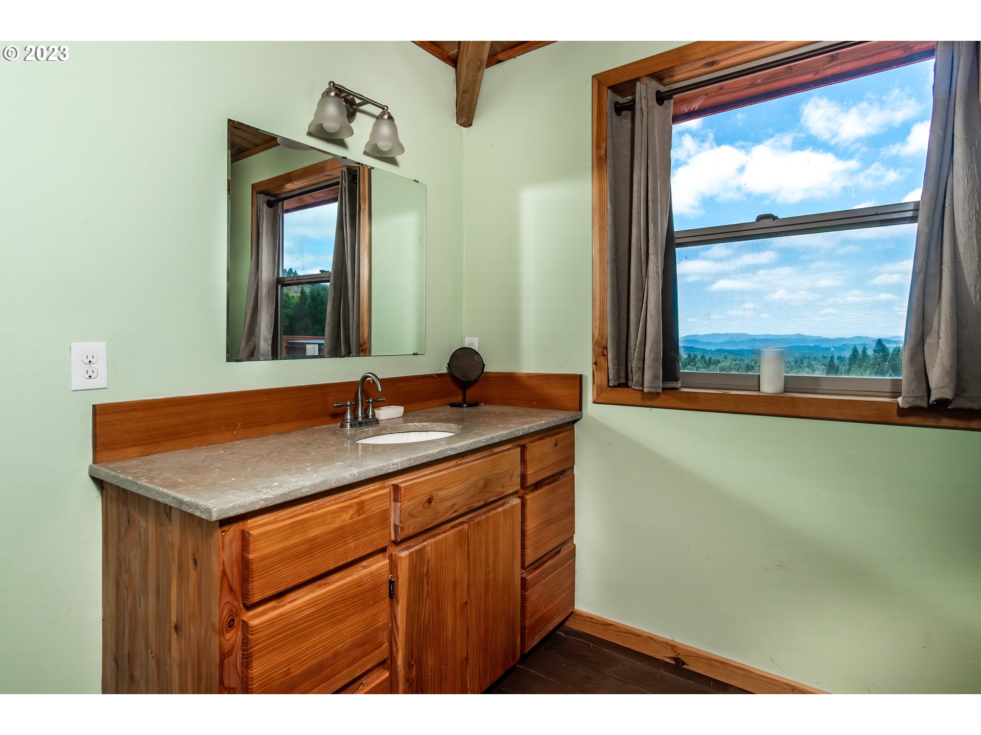 11937 Elkhead Road Yoncalla, OR 97499 - Photo 21 of 41 a bathroom with a sink and a mirror